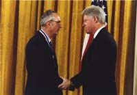 John Bahcall with President Clinton, receiving the 1998 National Medal of Science